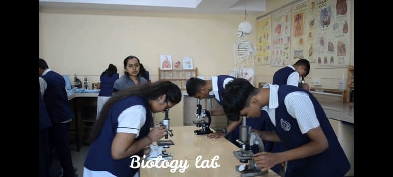 Students at microscopes in the biology lab