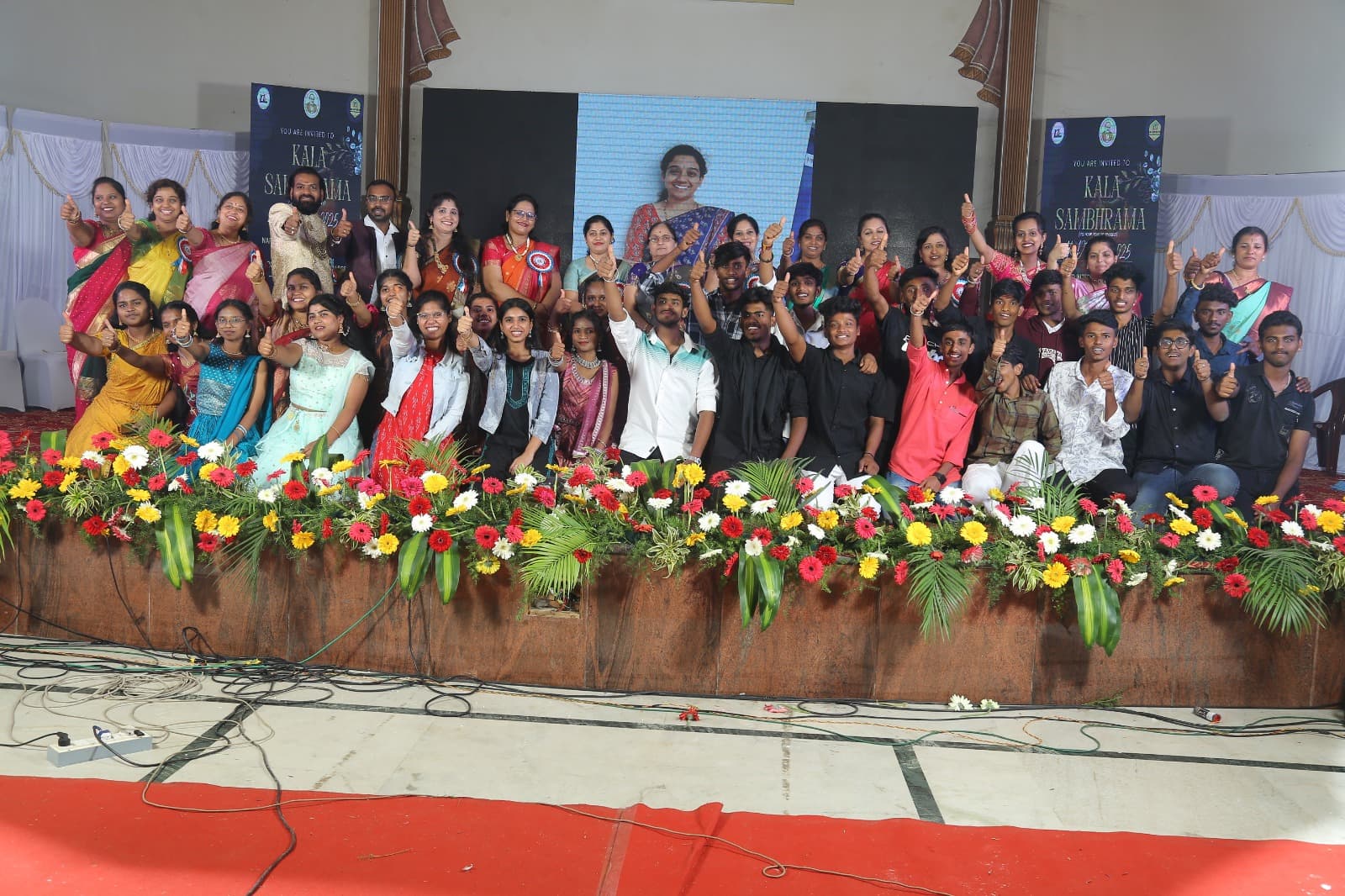 Students and staff on stage at the annual day