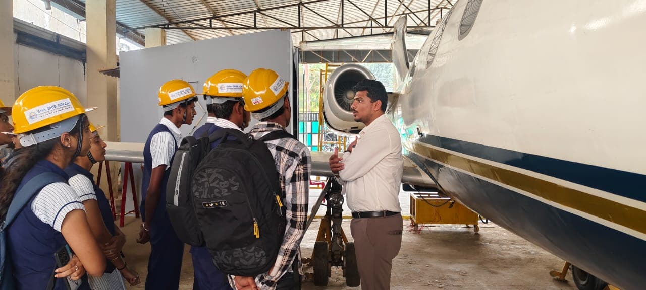 Students learning about aircraft systems in a hangar