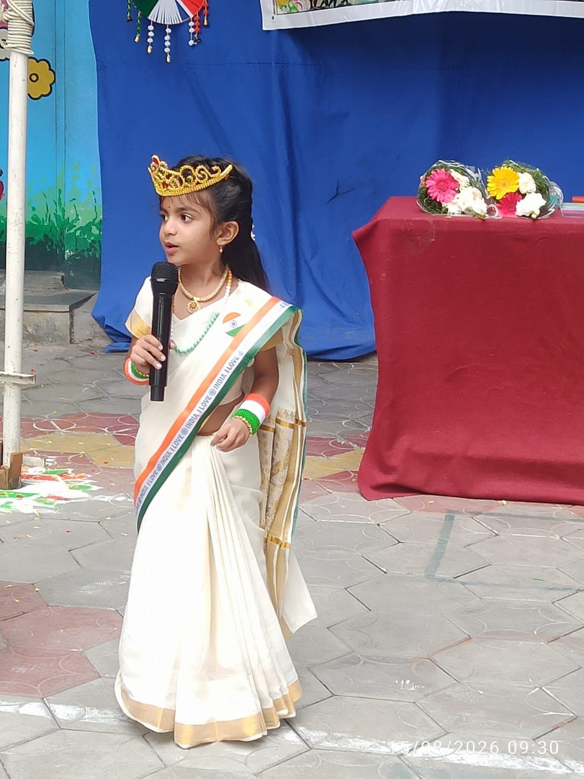 A young student in costume speaking on Independence Day