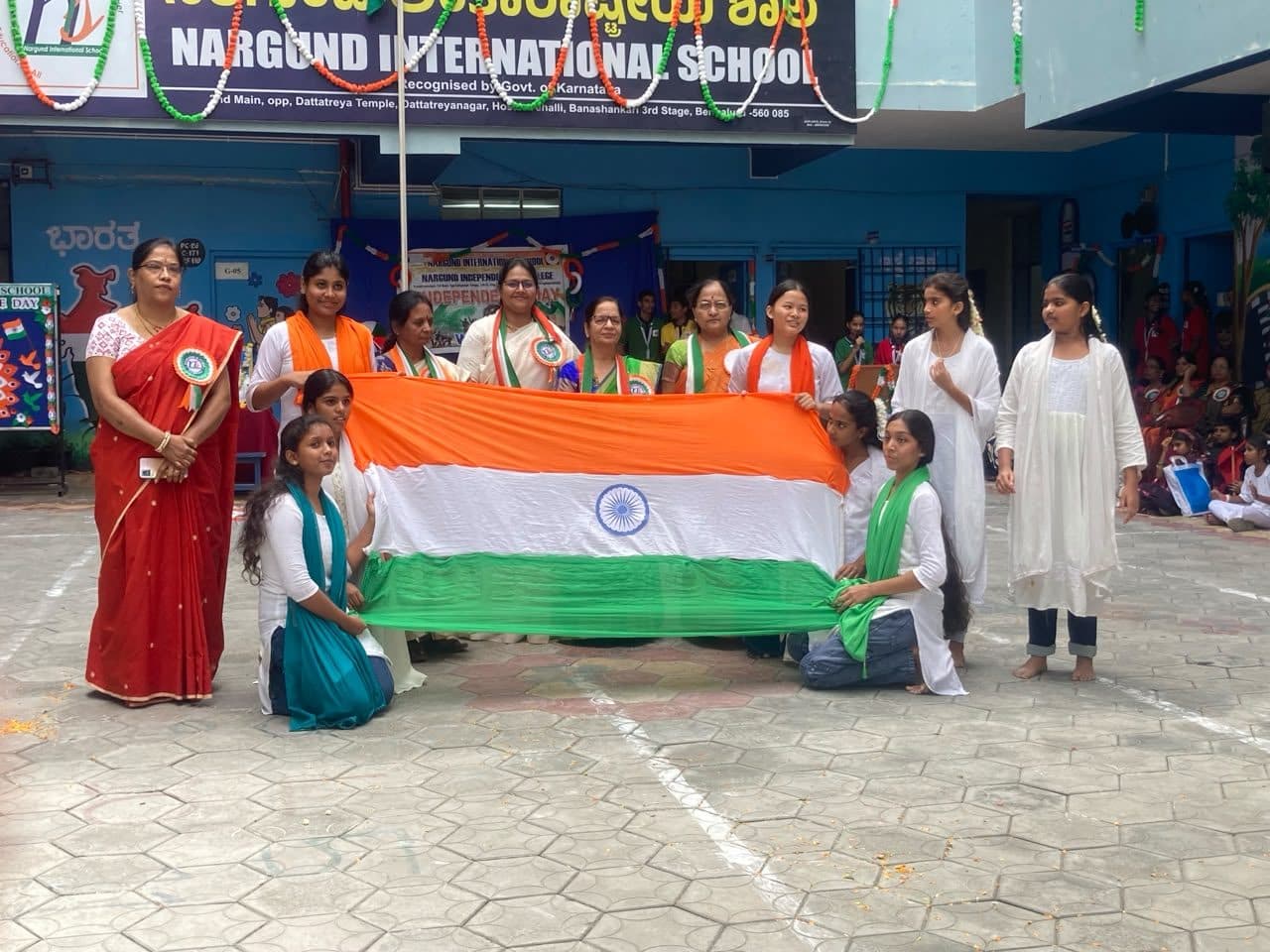 Teachers and students holding the national flag