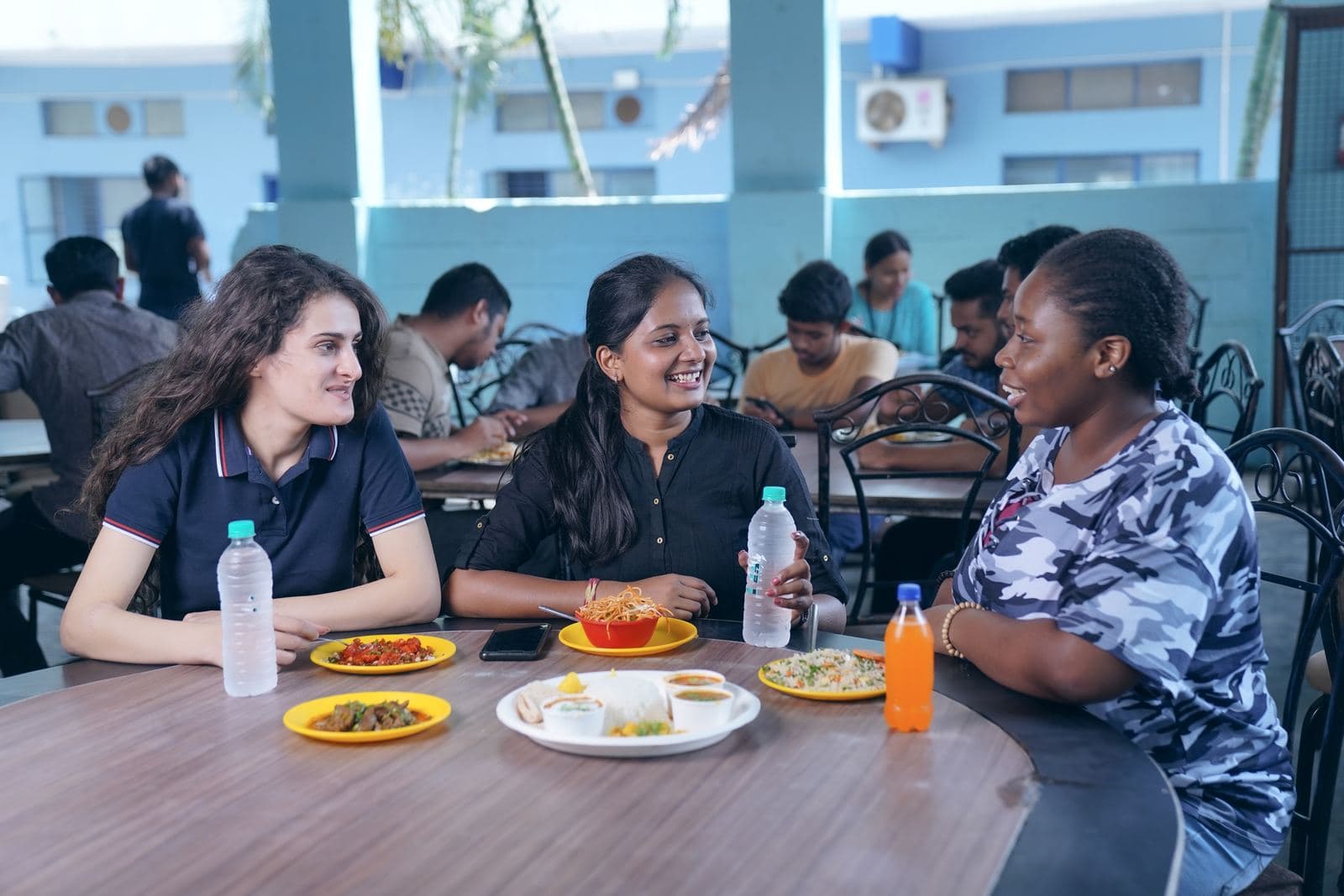 Students chatting over lunch in the canteen