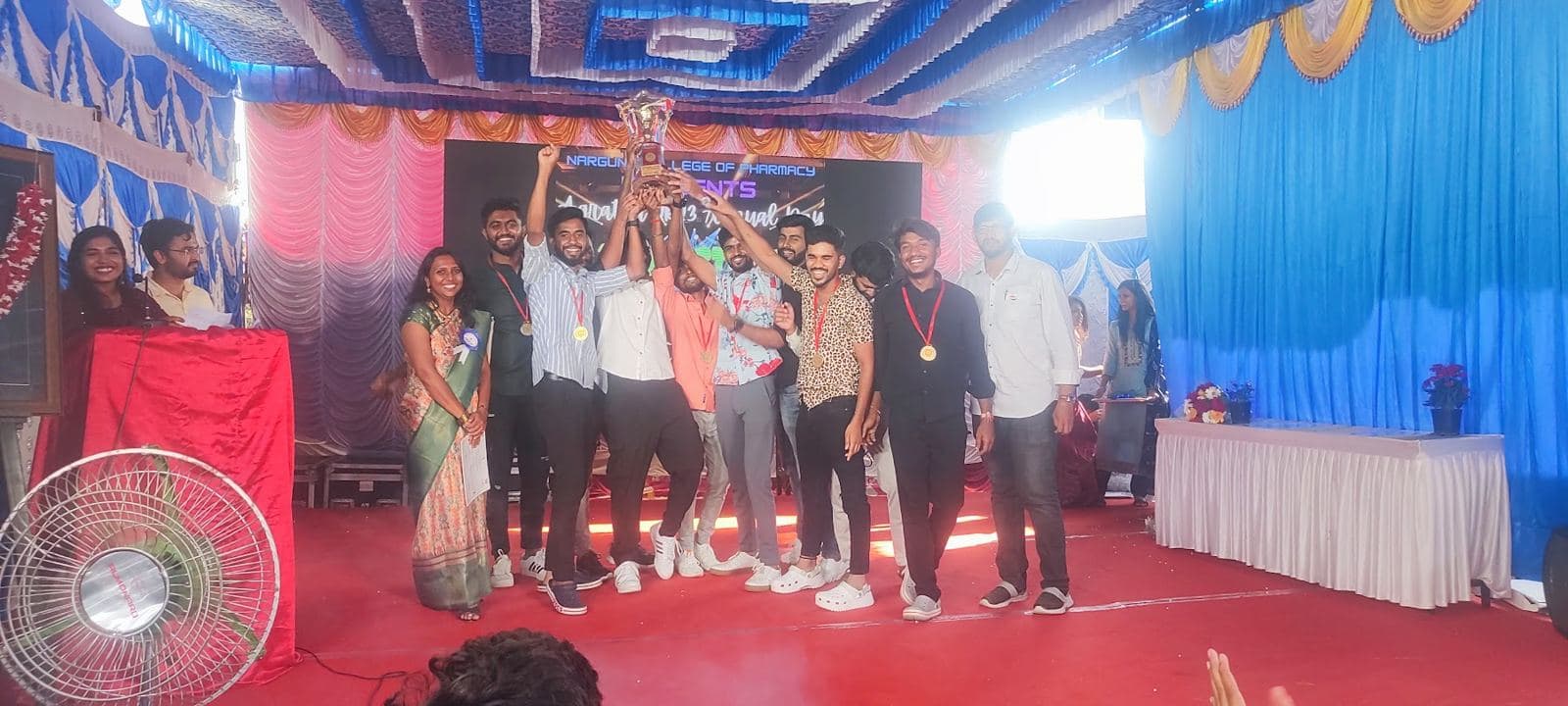 Students lifting the championship trophy