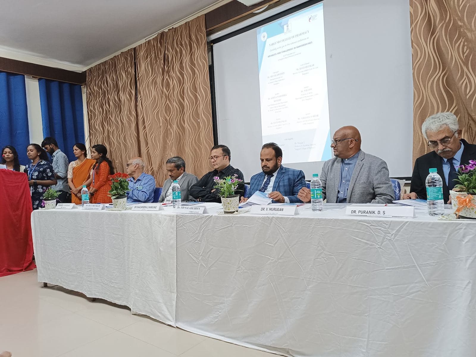 Speakers on the dais at a college seminar