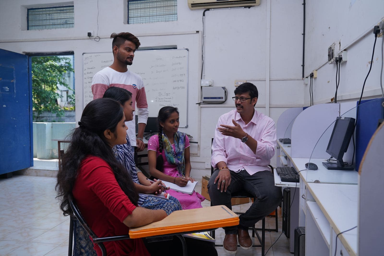 A faculty member mentoring a group of students