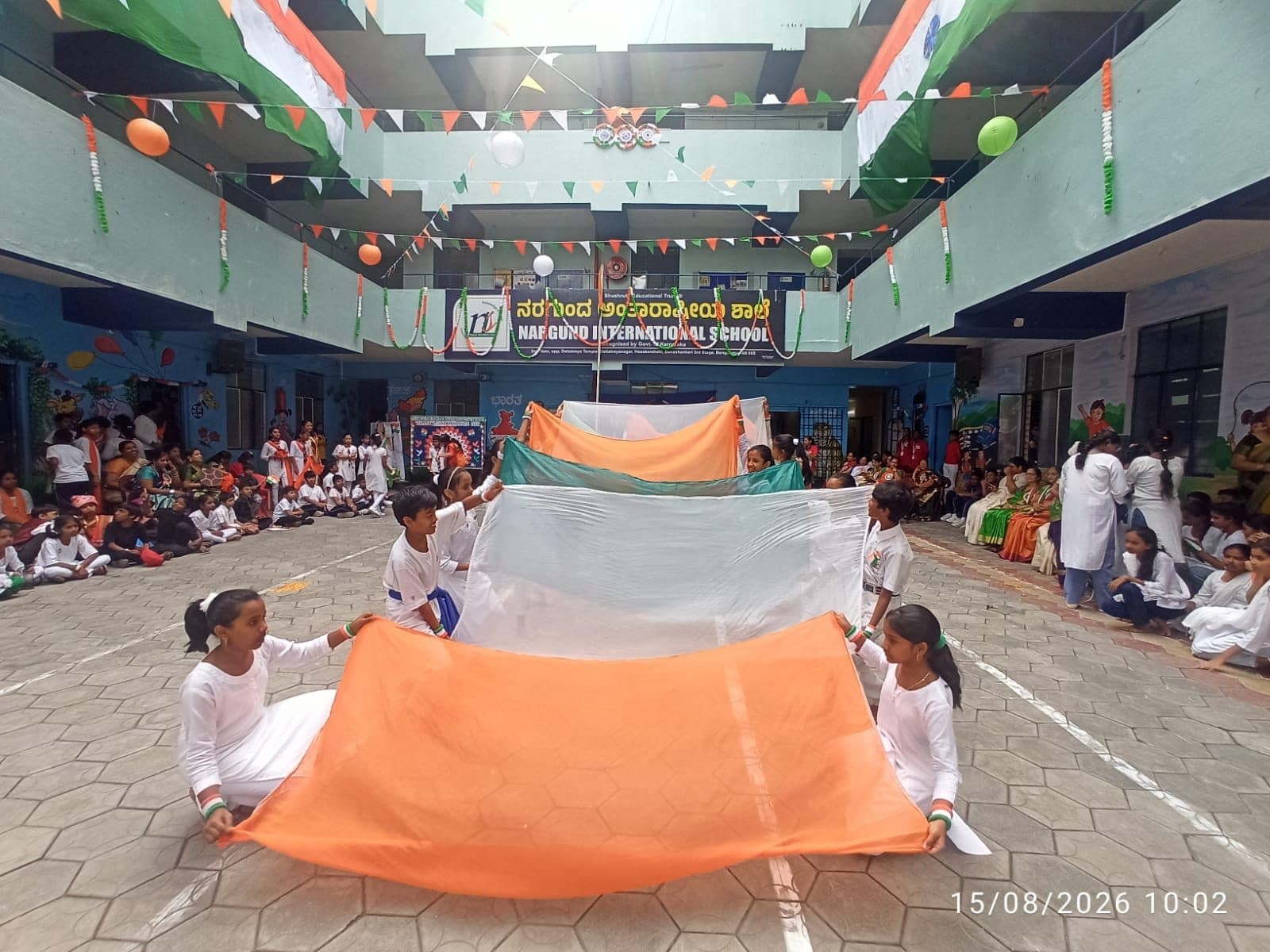 Students unfurling a giant tricolour in the courtyard on Independence Day