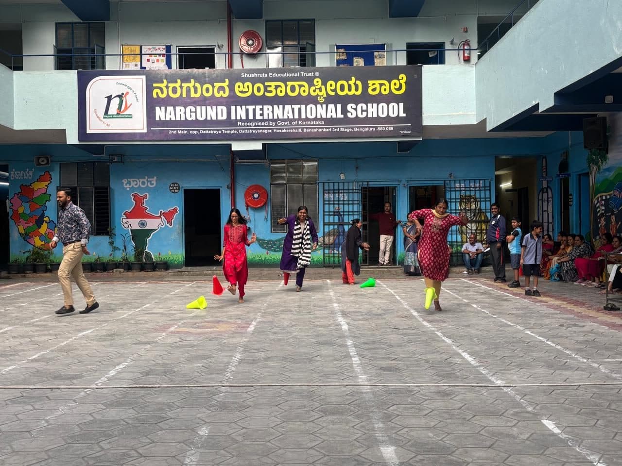 Parents playing games in the school courtyard