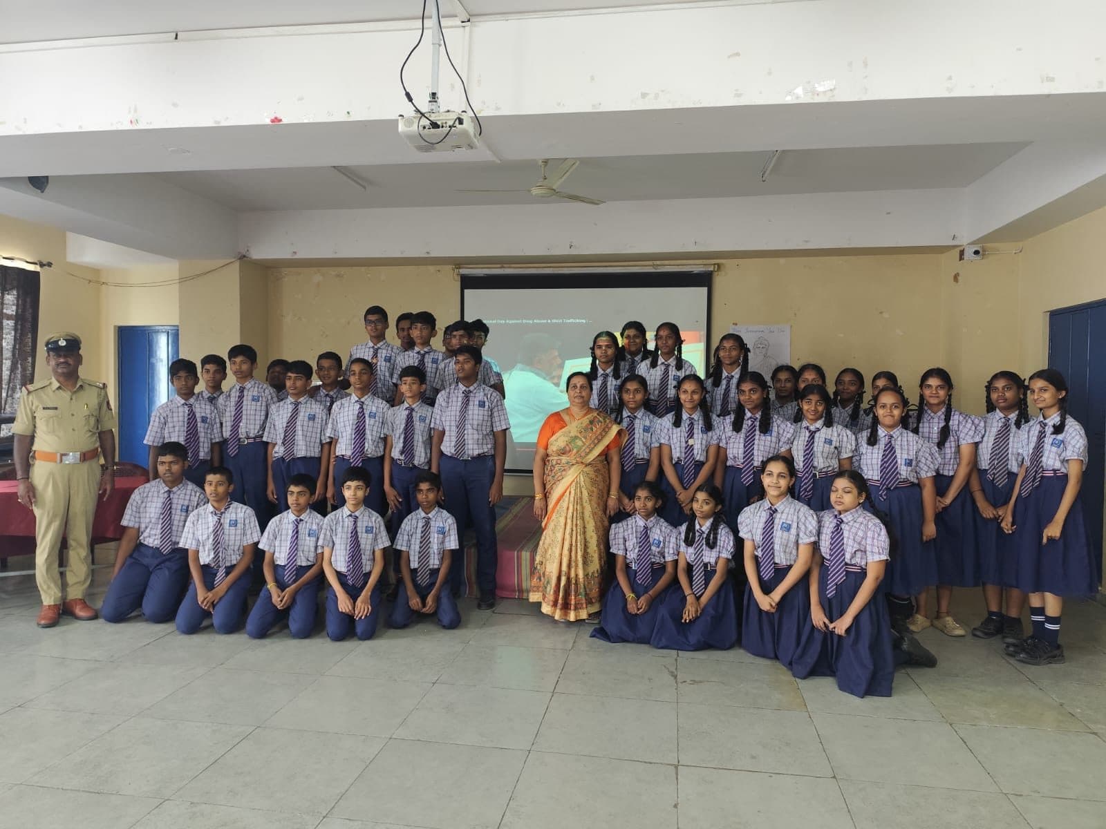 Students with a police officer after an awareness talk