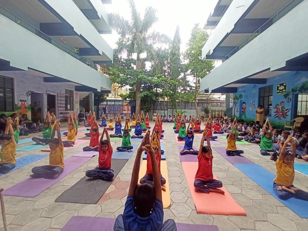 Students practising yoga in the courtyard